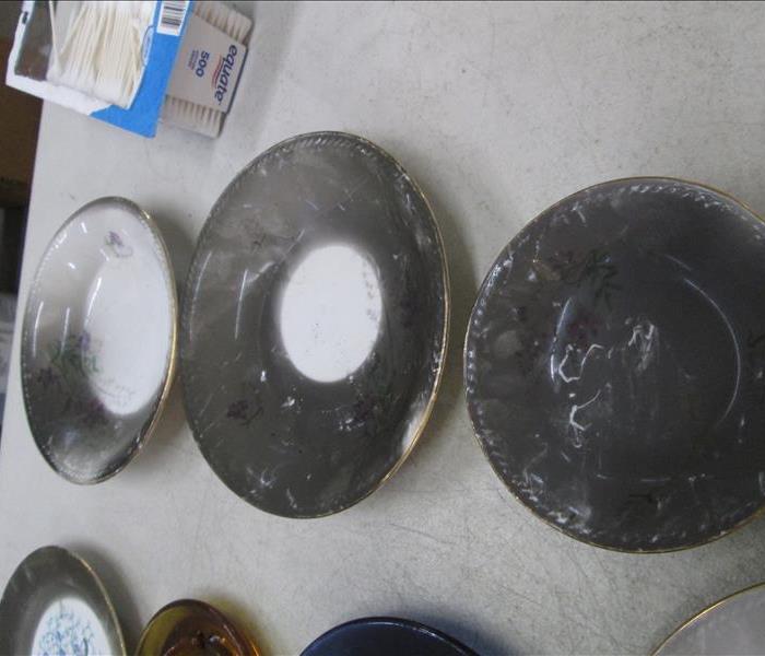 Three plates covered with soot